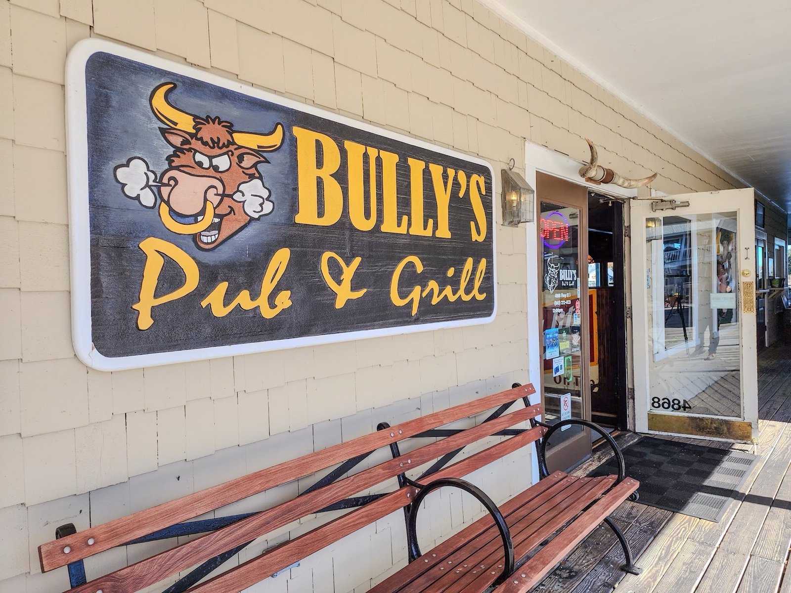 The Bully's entrance on the boardwalk, carved bull sign and bench